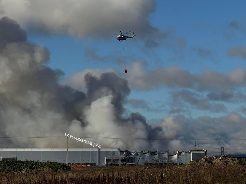 Helicopter is involved in battling fire at the warehouses in St.Petersburg